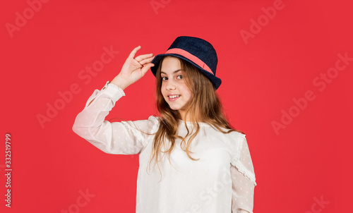 Feeling fancy. Summer accessory collection. Child long hair wear hat. Accessories shop. Outfit inspiration. Individual style. Girl wear hat red background. Happy kid in hat. Fashion accessory