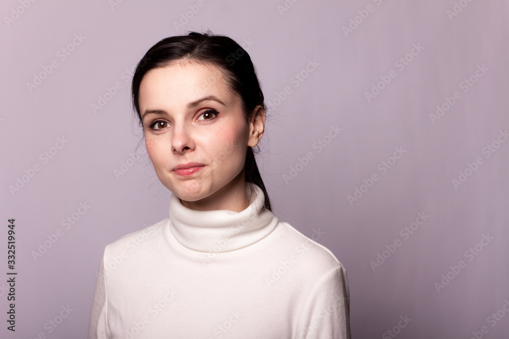girl in a white turtleneck, portrait on a gray background girl in a white turtleneck, portrait on a gray background
