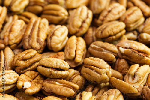 Pecan nuts background. Closeup pekan seeds