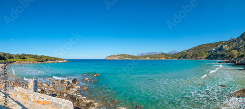 Fototapeta Naklejka Na Ścianę i Meble -  Beautiful colorful beach at Crete island, Greece. Voulisma paradise beach with rocks and mountains. Summer vacation travel holiday background concept. Voulisma beach, Agios Nikolaos, Crete, Greece.