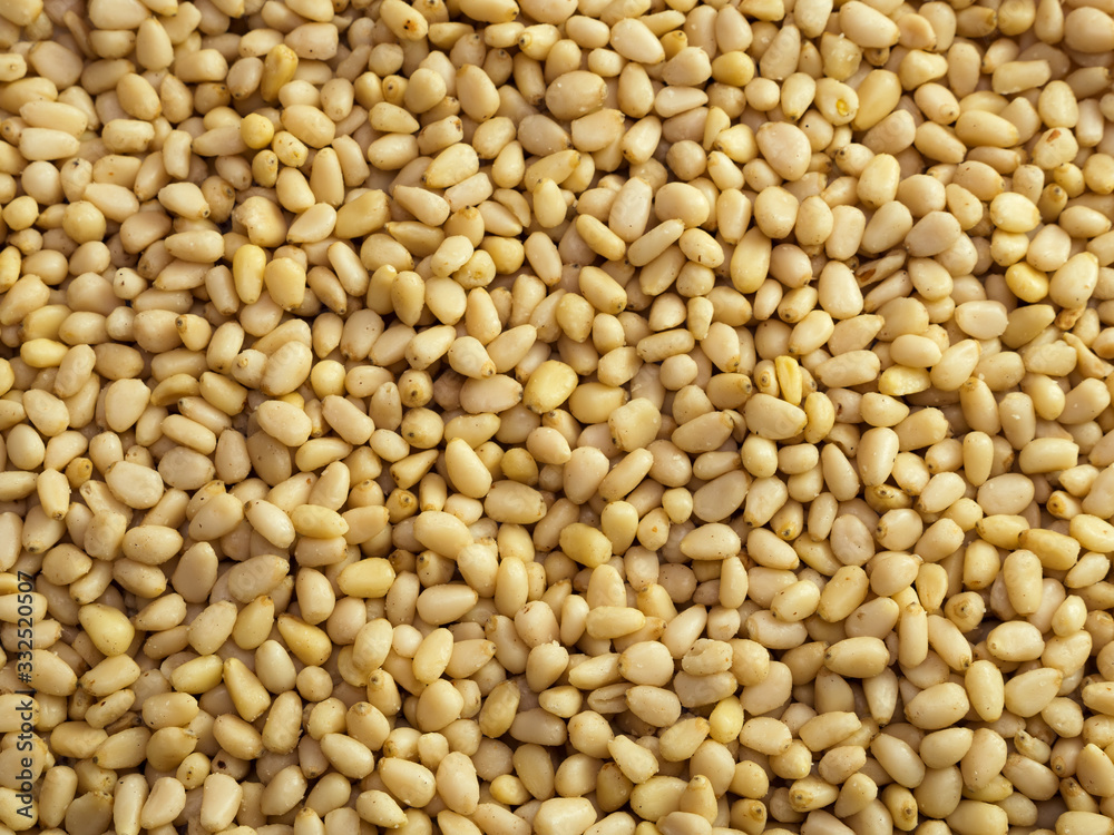 Pine nuts background. Unshelled cedar seeds, closeup Pine nuts background. Unshelled cedar seeds, closeup