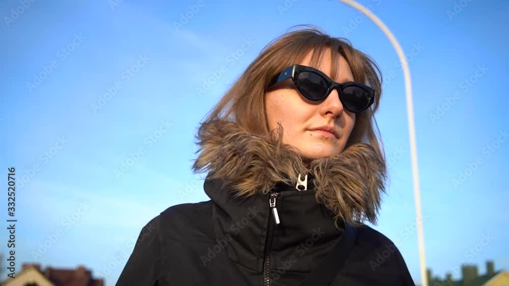 Portrait of young woman tourist in sunglasses walking on street in spring. Portrait of young woman tourist in sunglasses walking on street in spring.
