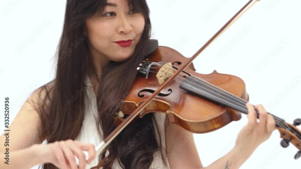 Smiling asian woman playing the violin on white background. Close up Smiling asian woman playing the violin on white background. Close up