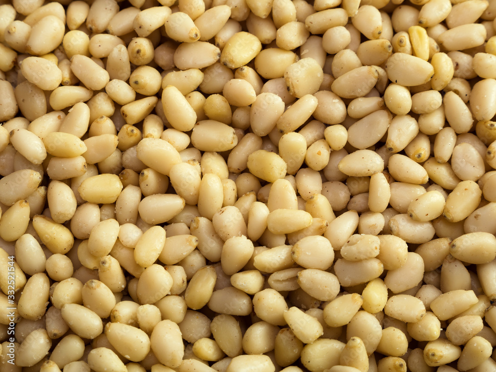 Pine nuts background. Unshelled cedar seeds, closeup Pine nuts background. Unshelled cedar seeds, closeup