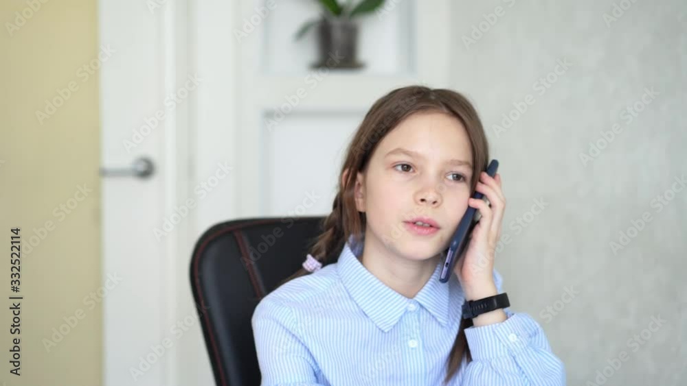Young girl using smartphone while sitting at home Young girl using smartphone while sitting at home