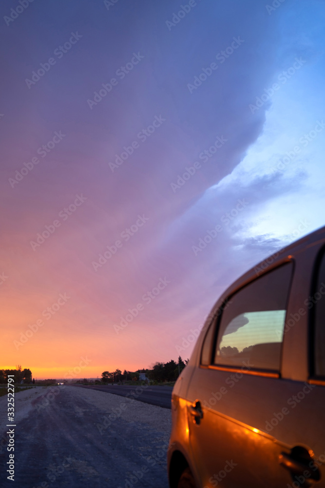 Car on a road at sunset