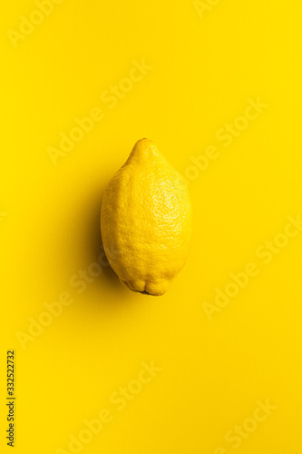 Yellow lemon fruit on yellow background. photo