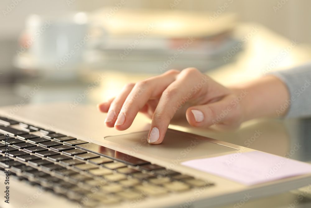 Woman hand with laptop using touchpad on a desk - obrazy, fototapety, plakaty 