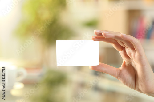 Woman hand showing mockup credit card at home