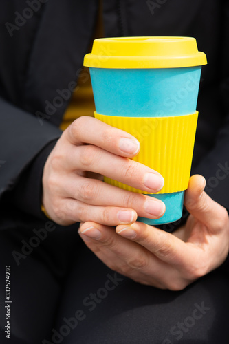 Female hands hold reusable coffee mug.Sustainable lifestyle concept.