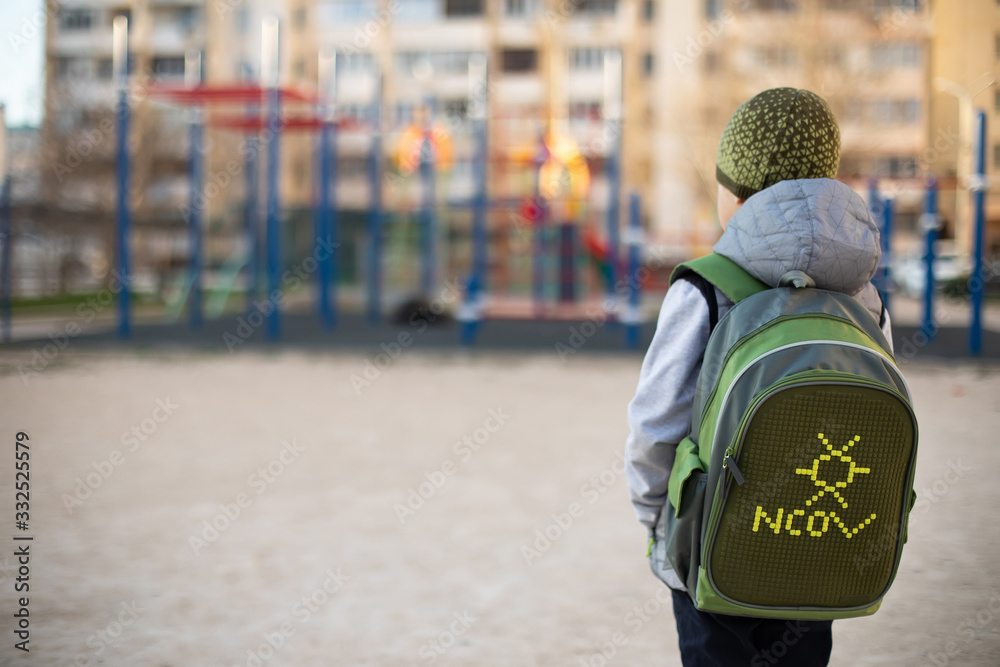 A school boy in front of the empty playground during coronavirus quarantine. A school boy in front of the empty playground during coronavirus quarantine.