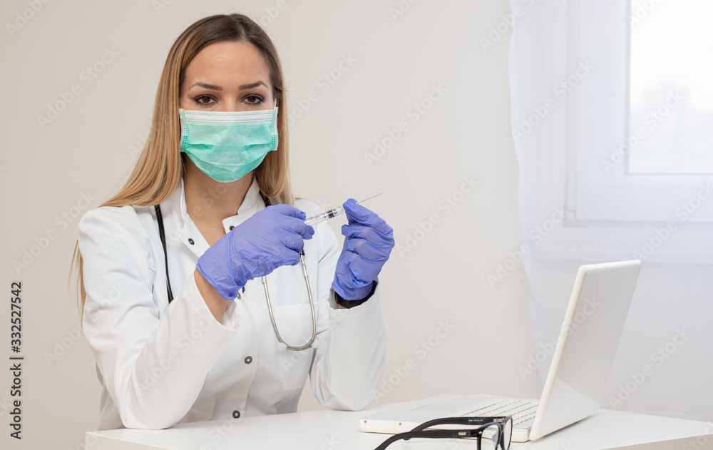 Female doctor holding syringe with injection
