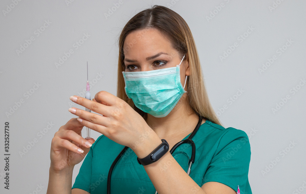 Female doctor holding syringe with injection Female doctor holding syringe with injection