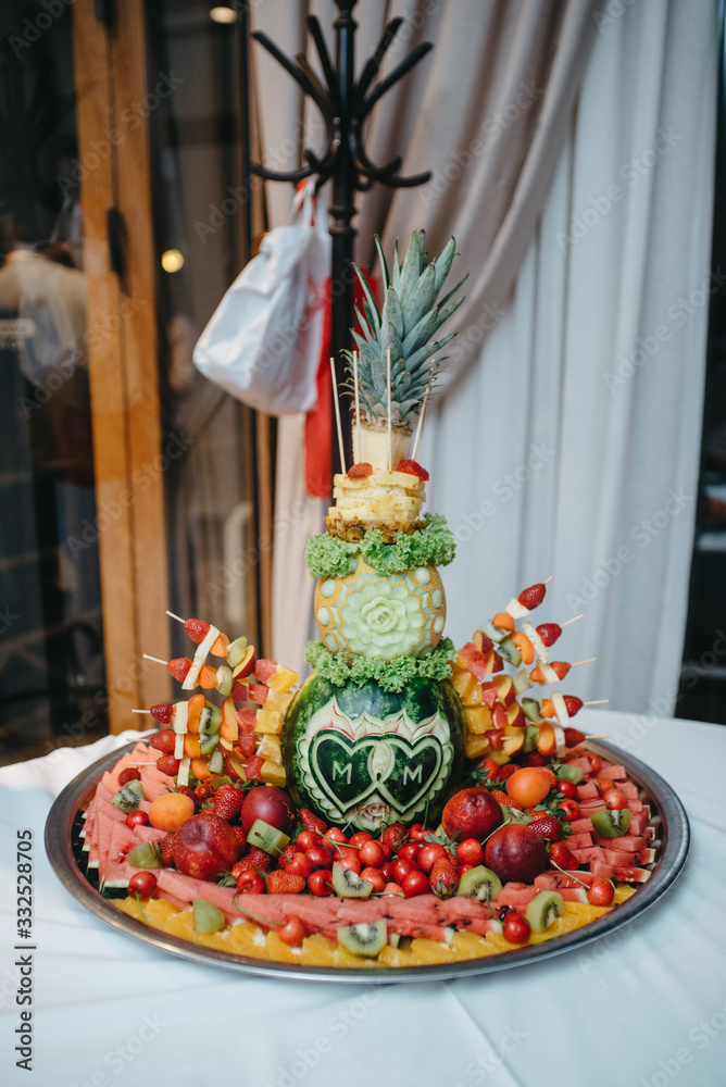 A table full of fresh arranged fruit for a party
