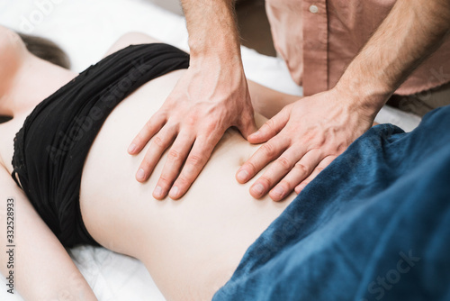 a man does a woman a massage of the abdomen  osteopathy 4