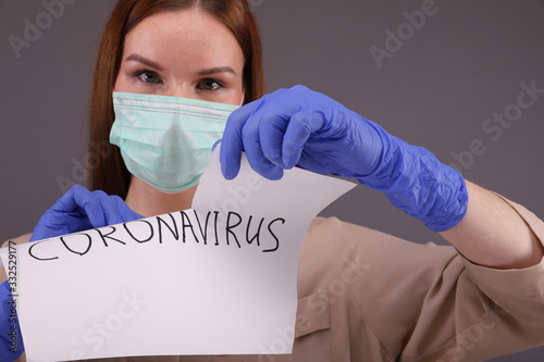 Woman tears sheet of paper with sign 