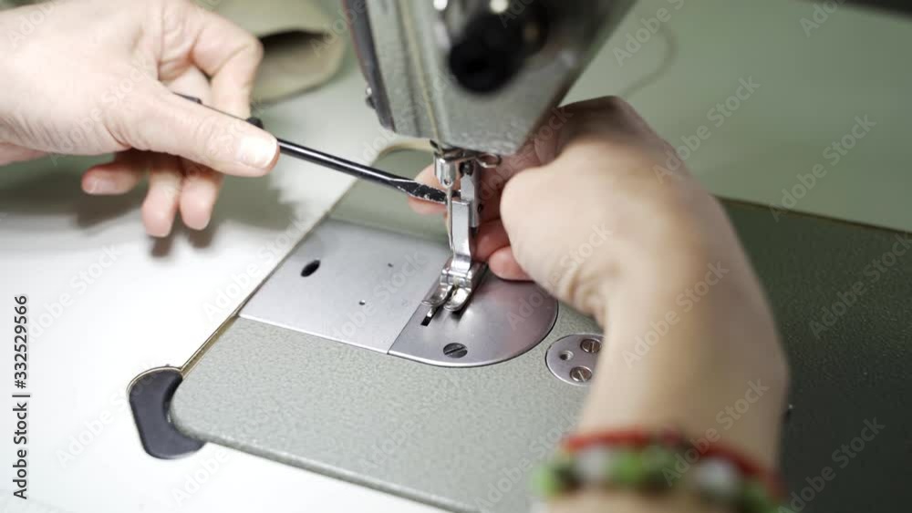 Work in the Atelier of female hands at the sewing machine closeup Work in the Atelier of female hands at the sewing machine closeup