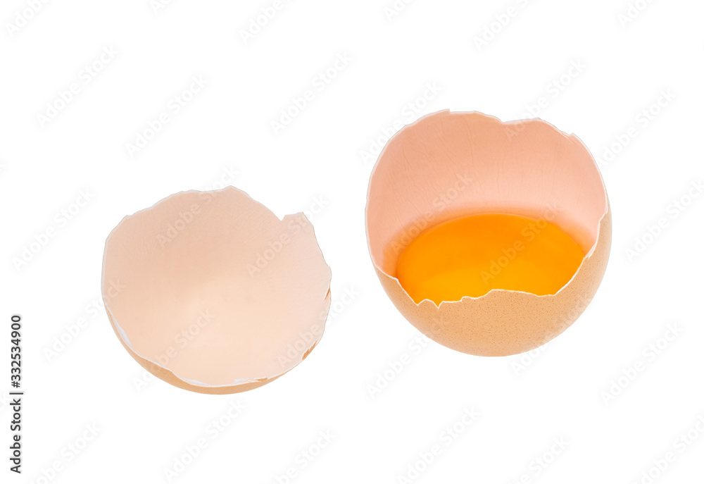 Broken egg isolated on a white background. half broken egg with yolk. Top view. Broken egg isolated on a white background. half broken egg with yolk. Top view.