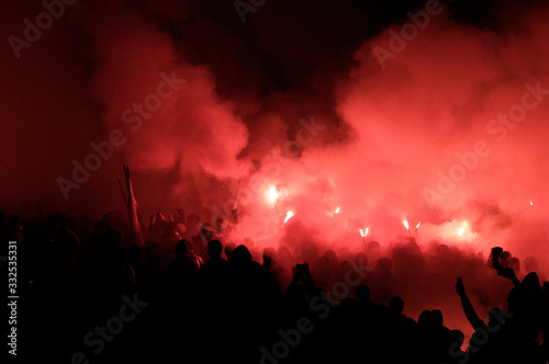 football fans use pyrotechnics after their club win championship. great bonfire of the yearly celebration 