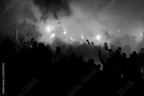  football fans use pyrotechnics after their club win championship. great bonfire of the yearly celebration 