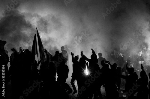  football fans use pyrotechnics after their club win championship.  great bonfire of the yearly celebration 