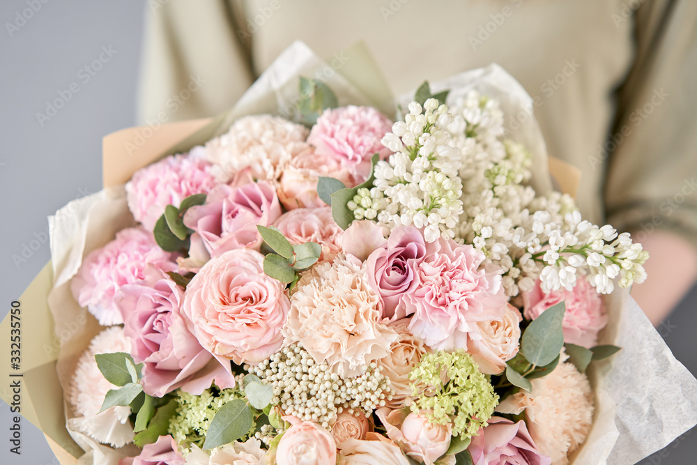 Small flower shop and Flowers delivery. Beautiful bouquet of mixed flowers in woman hands. Work of the florist at a flower shop. Delivery fresh cut flower. Small flower shop and Flowers delivery. Beautiful bouquet of mixed flowers in woman hands. Work of the florist at a flower shop. Delivery fresh cut flower.