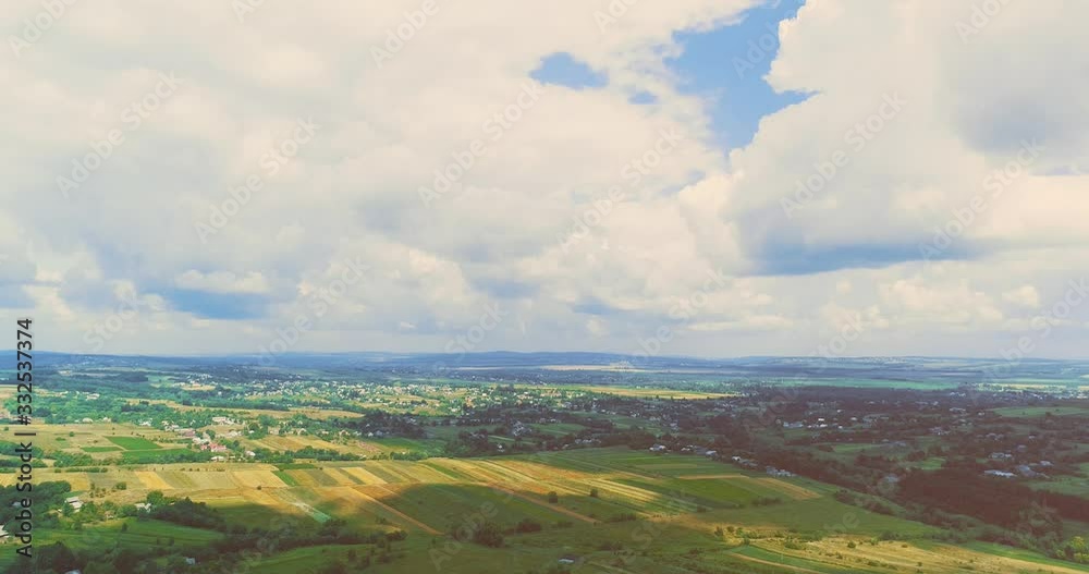 Drone view of beautiful farmland with lush greenery and crops ready to harvest under clear blue sky. Drone view of beautiful farmland with lush greenery and crops ready to harvest under clear blue sky.