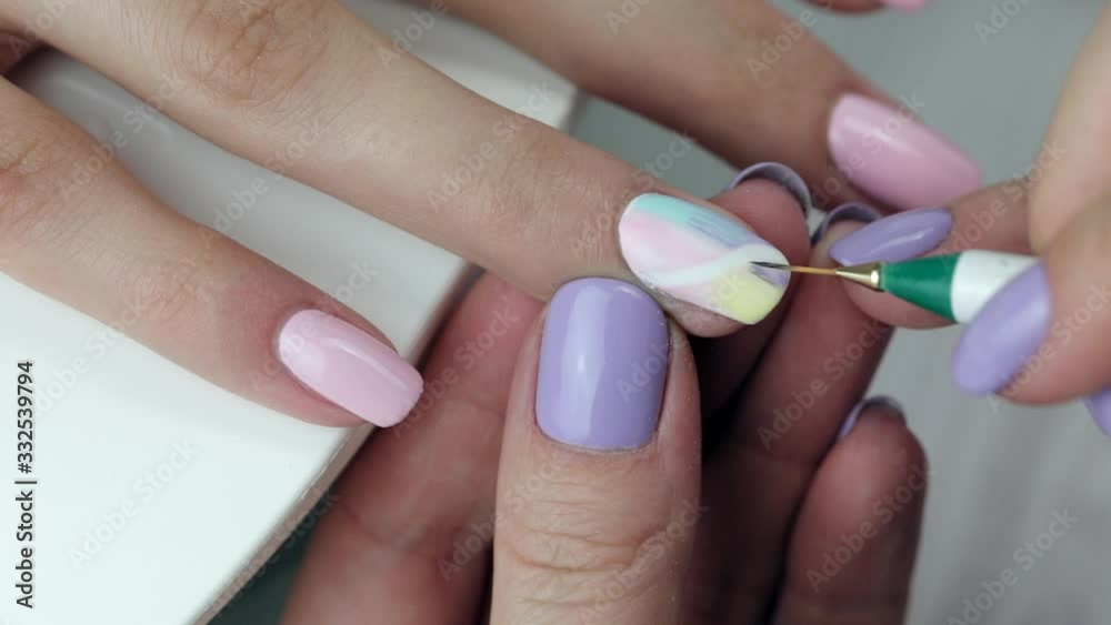 Manicure in progress - Beautiful manicured woman's nails with light nail polish. Manicure in progress - Beautiful manicured woman's nails with light nail polish.