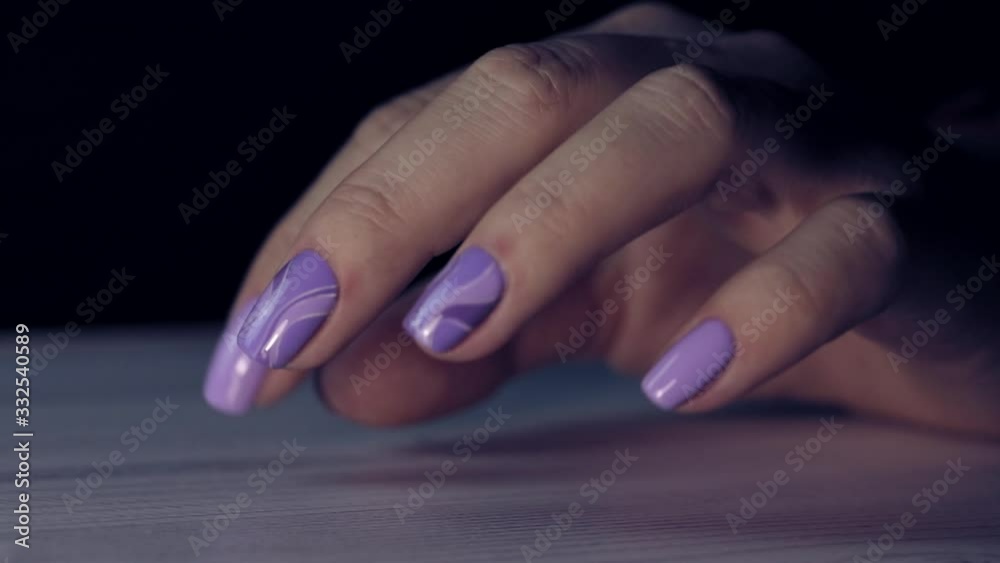 Beautiful female hands with violet manicure. Fingers with fresh e look manicure at short nails. Trend of natural beauty concept. Beautiful female hands with violet manicure. Fingers with fresh e look manicure at short nails. Trend of natural beauty concept.