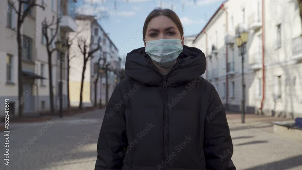 Portrait of a young tourist woman wearing protective mask on empty european streets. Pandemic Covid-19 coronavirus protection. Portrait of a young tourist woman wearing protective mask on empty european streets. Pandemic Covid-19 coronavirus protection.