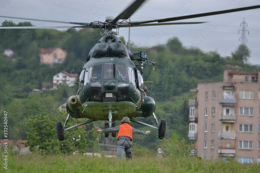 A UN helicopter flies across the field to save people from the flood. A UN helicopter flies across the field to save people from the flood.