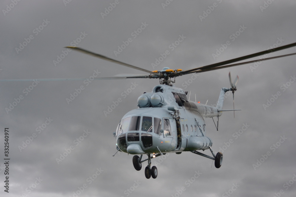 A UN helicopter flies across the field to save people from the flood. A UN helicopter flies across the field to save people from the flood.
