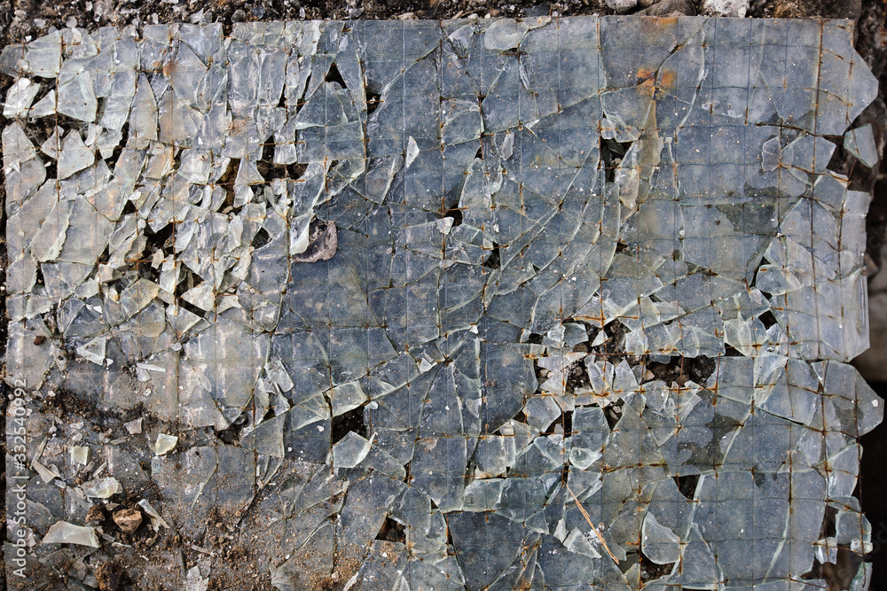 Fototapeta premium Broken glass on floor background, top view, abstract