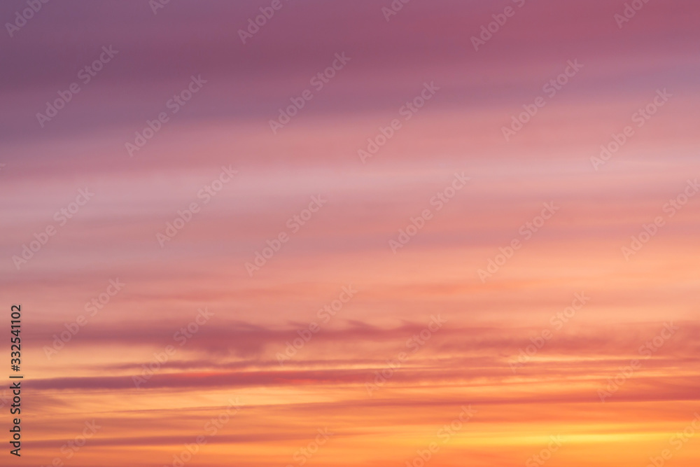 Dramatic bright soft sunrise, sunset pink orange red sky with clouds background texture