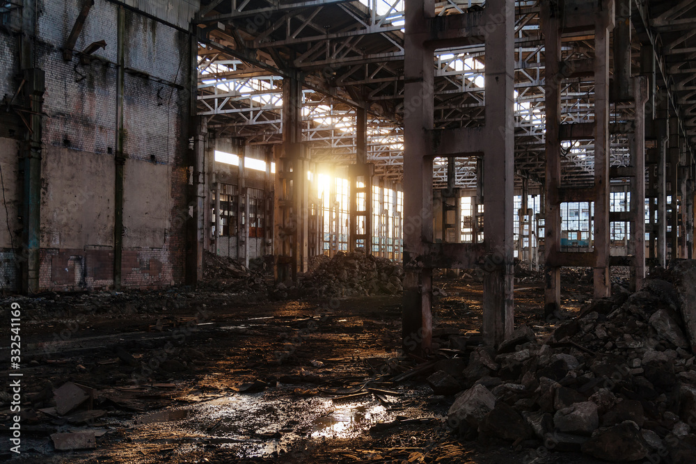 Sunlight of sunset in large abandoned industrial building of Voronezh excavator factory