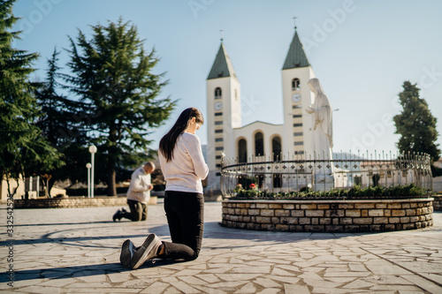 Fotografija Religious woman praying to God and Virgin Mary in Medjugorje