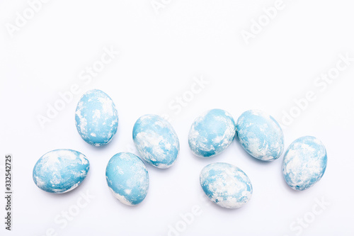 Stylish eggs with ombre blue marble stone effect on white background