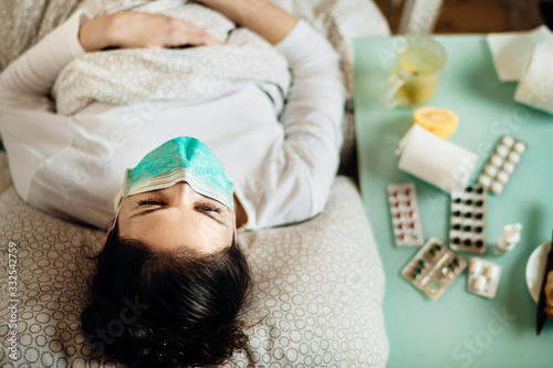 Sick woman with mask in mobile quarantine hospital units isolation.Coronavirus Covid-19 patient having pneumonia disease symptoms health care treatment.Attacked immune system.Medical help.Recovery photo