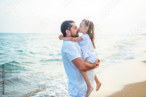 Gentle hugs and a kiss on the sea. Loving father and daughter on the sea coast, happy family © Yarkovoy