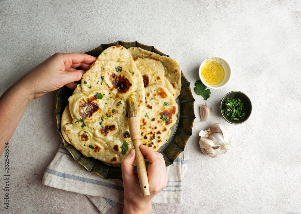 naan - garlic indian flat bread, tipical in Western Asia, South Asia, Myanmar and the Caribbean - obrazy, fototapety, plakaty 