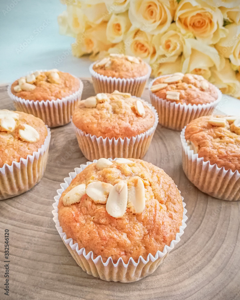 Muffins with peanut with roses on background Muffins with peanut with roses on background