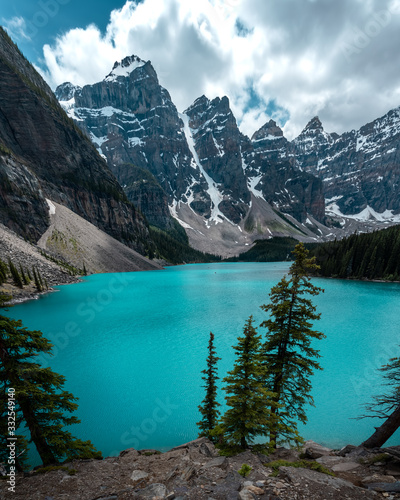 Iconic & Stunning Moraine Lake in Banff National Park, Alberta. Summer in beautiful Canada with turquoise, emerald green lake water in popular, tourism, tourists area near Calgary. 
