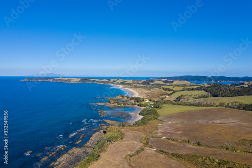 Aerial View from the Beach, Green Trees, City Streets and Waves of Omaha in New Zealand - Auckland Area 