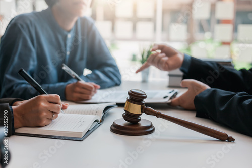 Business people and lawyers talk and contract together. Signing of a contract in the presence of an attorney.