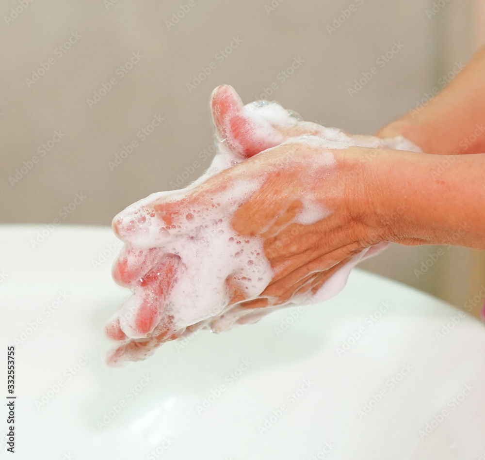 Fototapeta premium woman washing her hands in bathroom