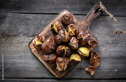 Roasted chestnuts on wooden background
