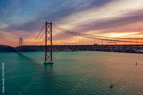 Lisbon, Portugal. Aerial view of the 25 de Abril Bridge (Ponte 25 de Abril, 25th of April Bridge) at sunset. It is often compared to the Golden Gate Bridge in San Francisco, US.