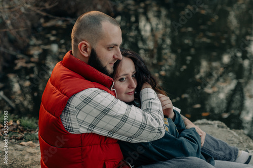 happy couple hugging on a lake in autumn