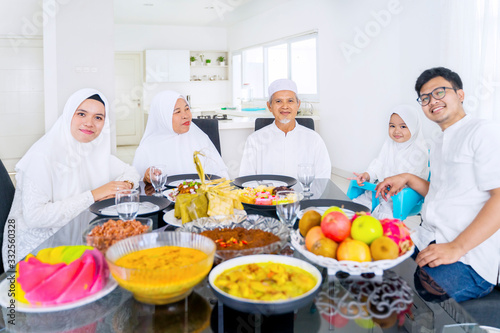 Happy muslim family smiling together in dining room