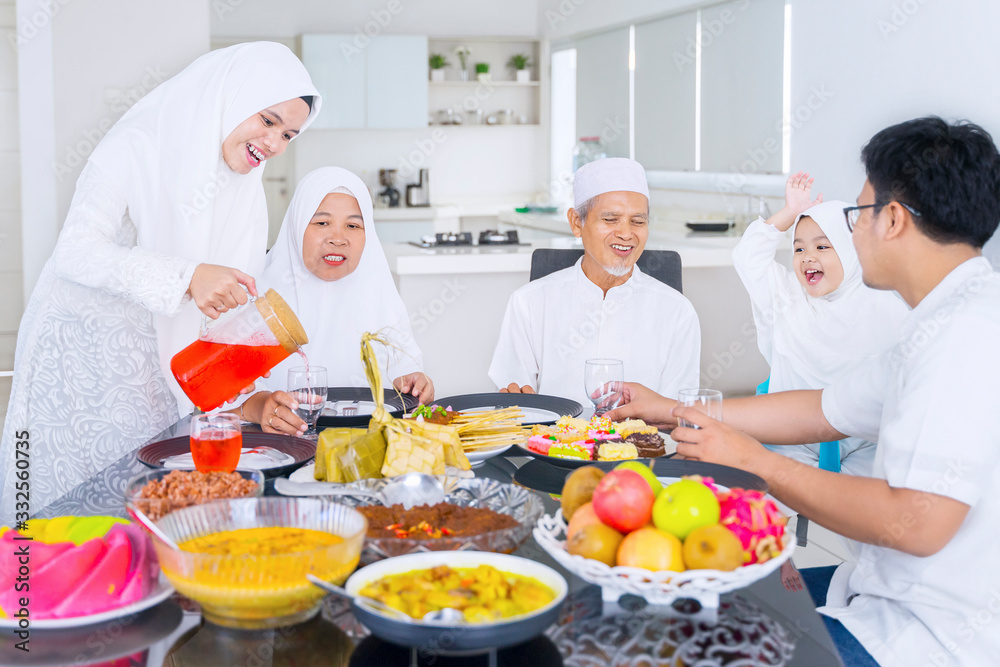 Muslim family eating together in dining room